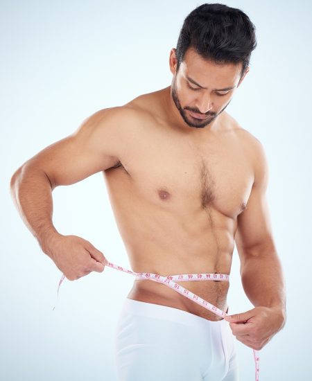 Man, body or measuring tape on waist on studio background for weight loss management, fat control o.